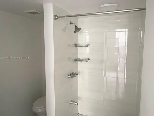 a bathroom with a shower and a sink