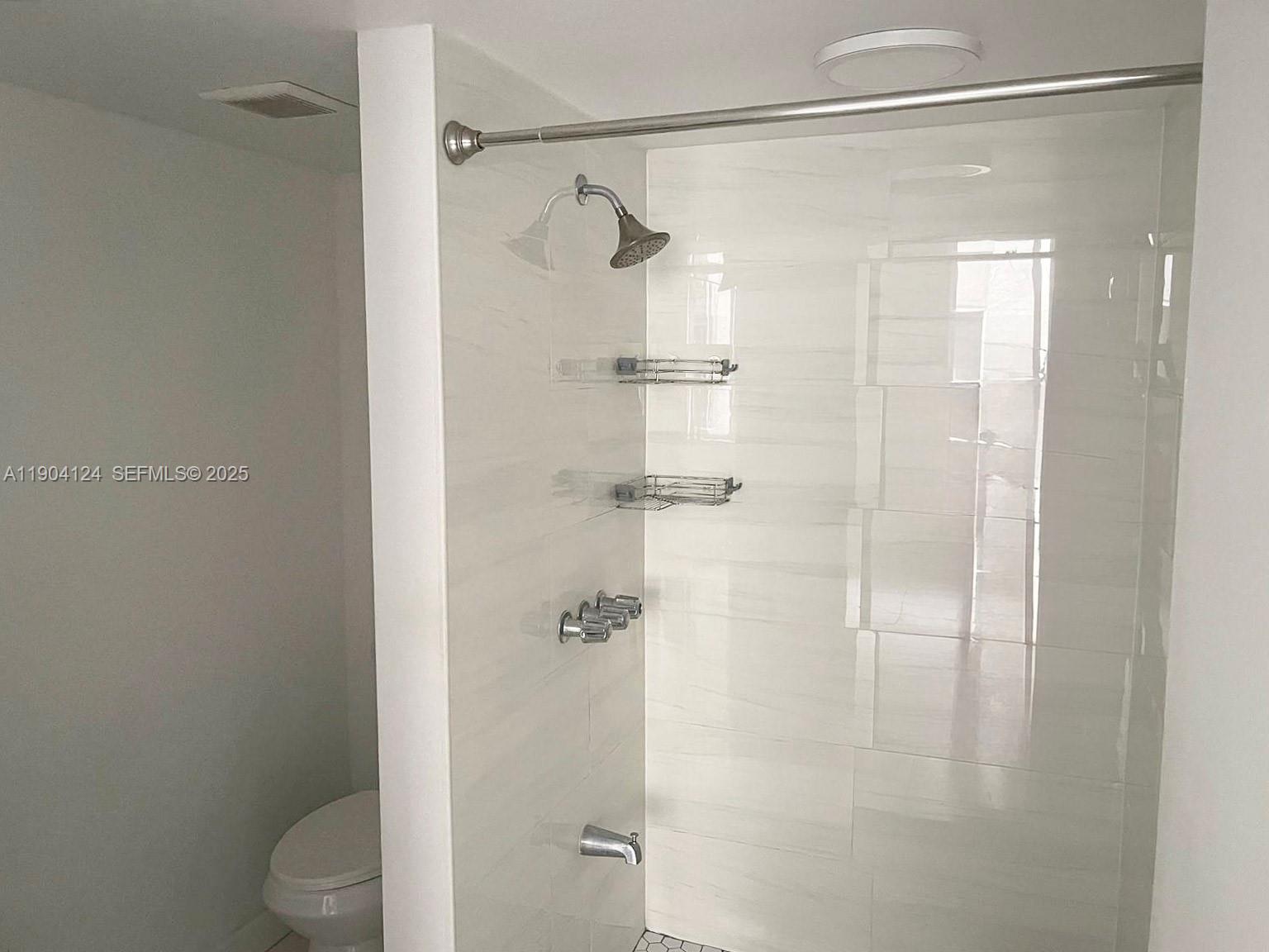 10090 Northwest 80th Court, Unit 1340 Hialeah Gardens, FL 33016 - Photo 11 of 17 a bathroom with a shower and a toilet