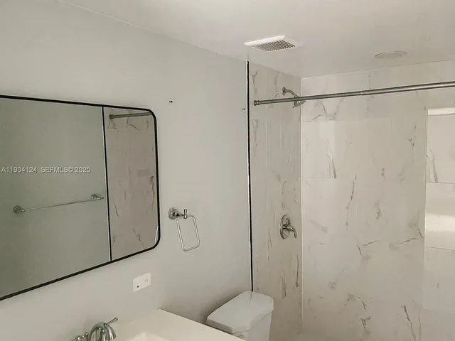 a bathroom with a sink vanity and a mirror