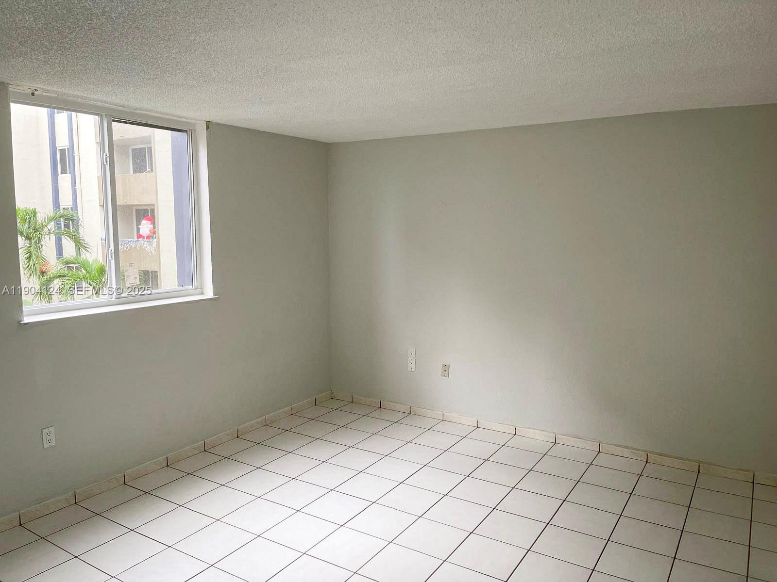 10090 Northwest 80th Court, Unit 1340 Hialeah Gardens, FL 33016 - Photo 17 of 17 a view of an empty room and window