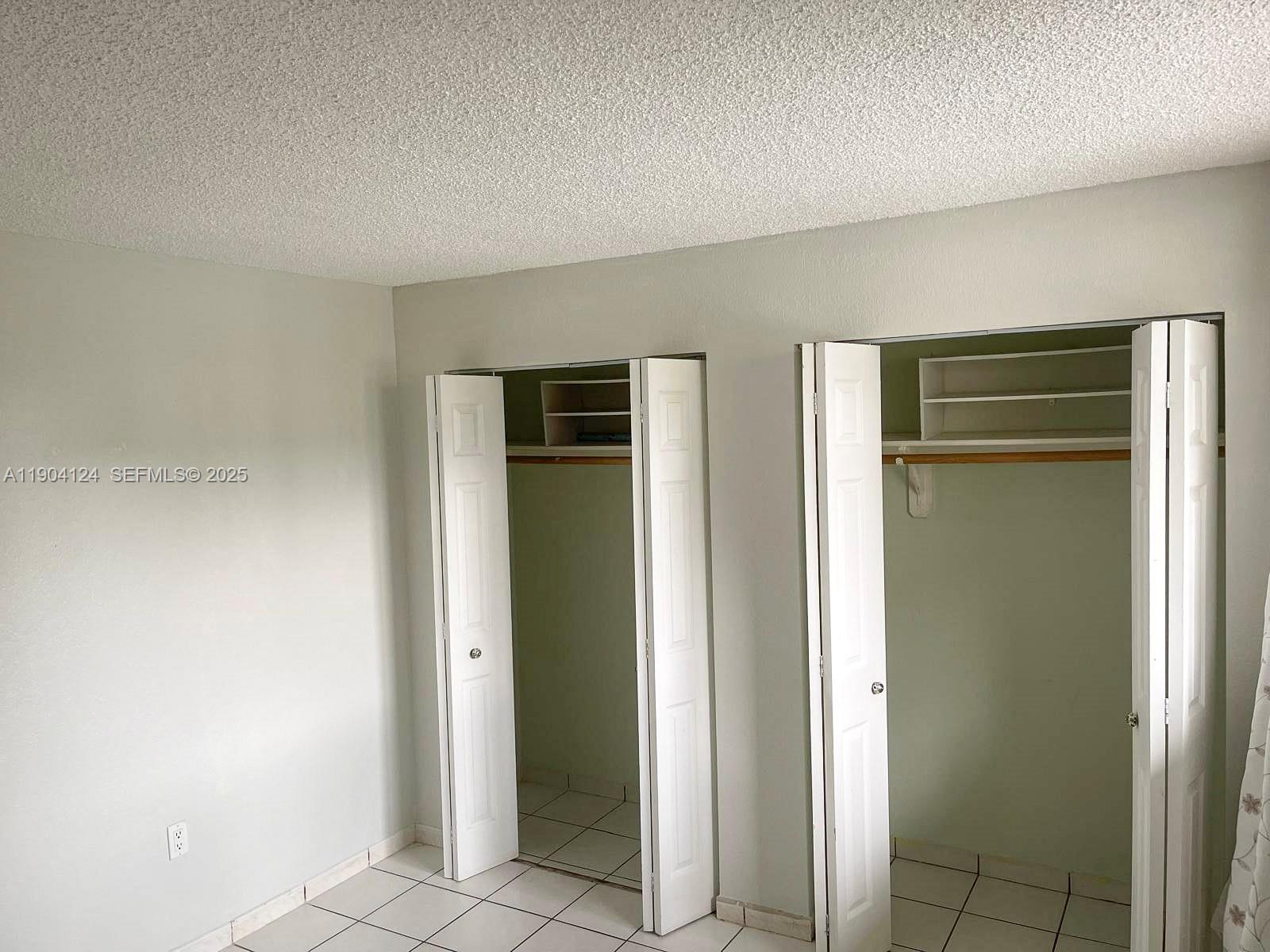 10090 Northwest 80th Court, Unit 1340 Hialeah Gardens, FL 33016 - Photo 10 of 17 a view of an empty room and window