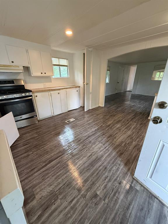a view of a kitchen with wooden floor and electronic appliances