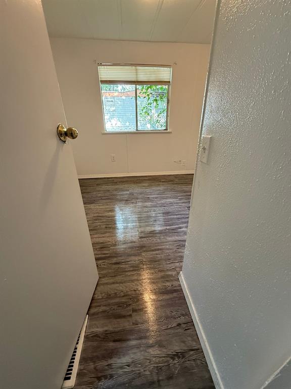 109 East Prospect Street Denison, TX 75021 - Photo 16 of 16 a view of a hallway with wooden floor