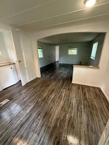 a kitchen with a sink a stove a microwave and wooden floor