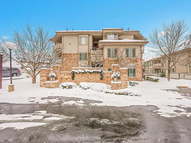 a view of a building with a yard covered with snow