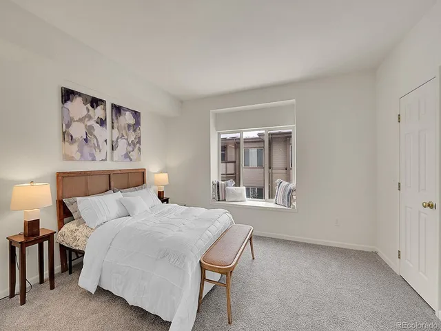 a bedroom with a large bed and a window