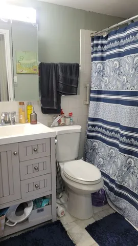 a bathroom with a toilet a sink and a mirror