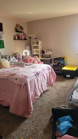 a bedroom with bed and a table