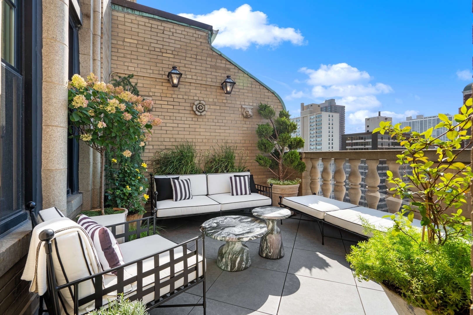 3100 North Sheridan Road, Unit 14B Chicago, IL 60657 - Photo 13 of 50 a view of a patio with couches table and chairs and potted plants