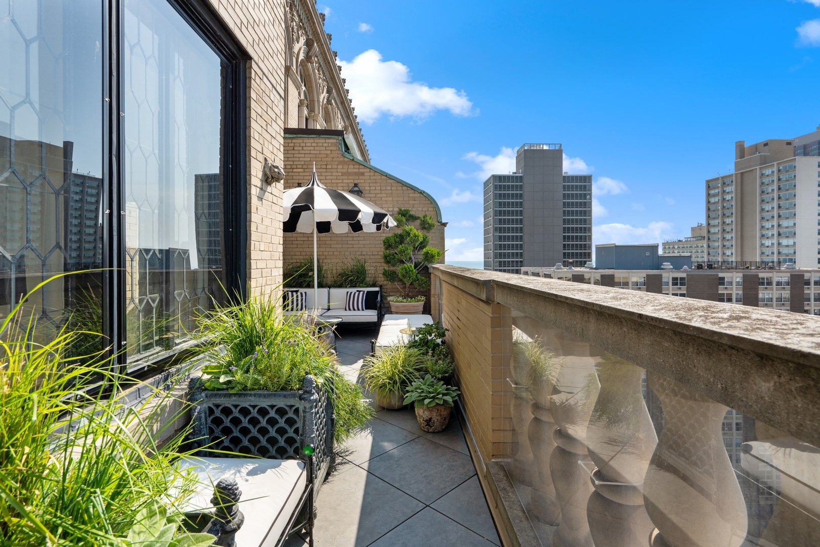 3100 North Sheridan Road, Unit 14B Chicago, IL 60657 - Photo 15 of 50 a balcony with potted plants and a bench