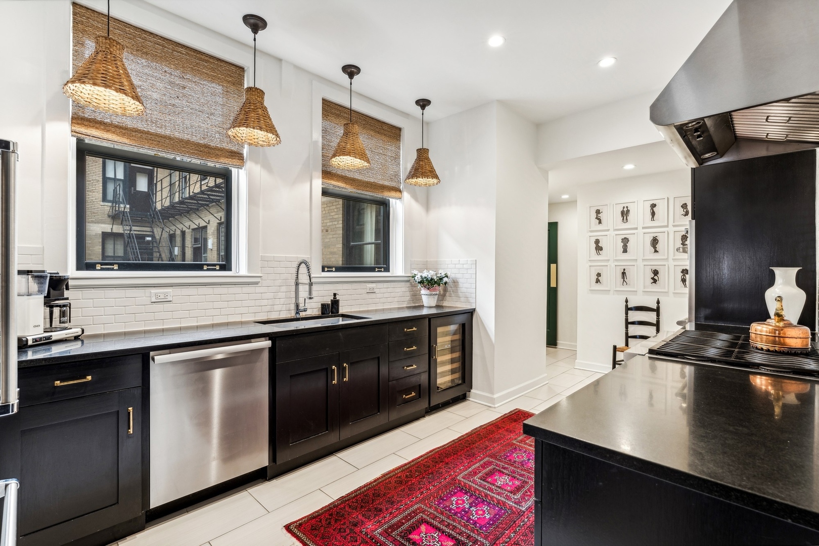 3100 North Sheridan Road, Unit 14B Chicago, IL 60657 - Photo 27 of 50 a kitchen with stainless steel appliances granite countertop a sink a stove and a microwave