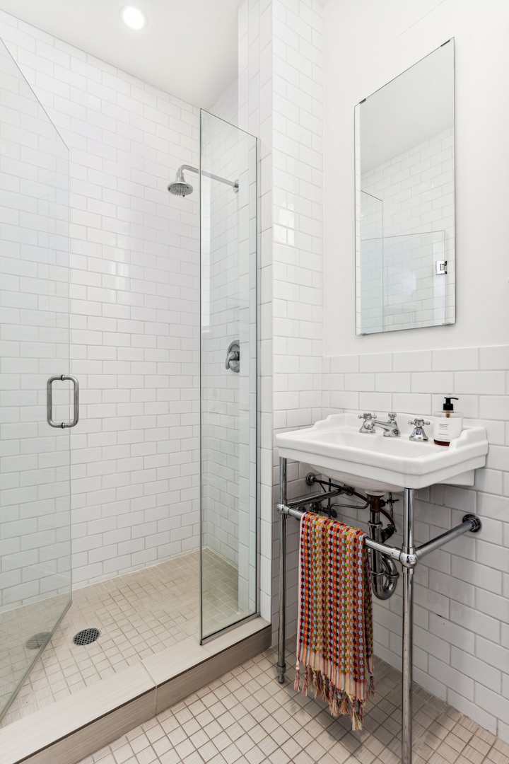 3100 North Sheridan Road, Unit 14B Chicago, IL 60657 - Photo 34 of 50 a bathroom with a sink a shower and a mirror