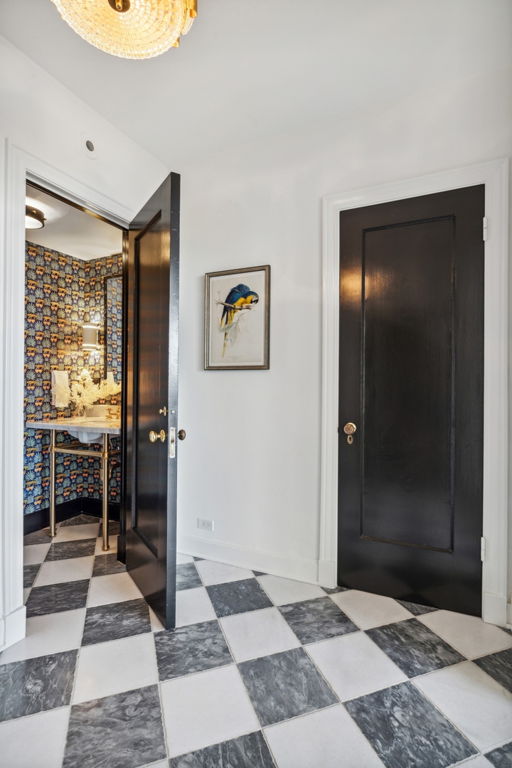 3100 North Sheridan Road, Unit 14B Chicago, IL 60657 - Photo 47 of 50 a view of a hallway with wooden floor and a bathroom
