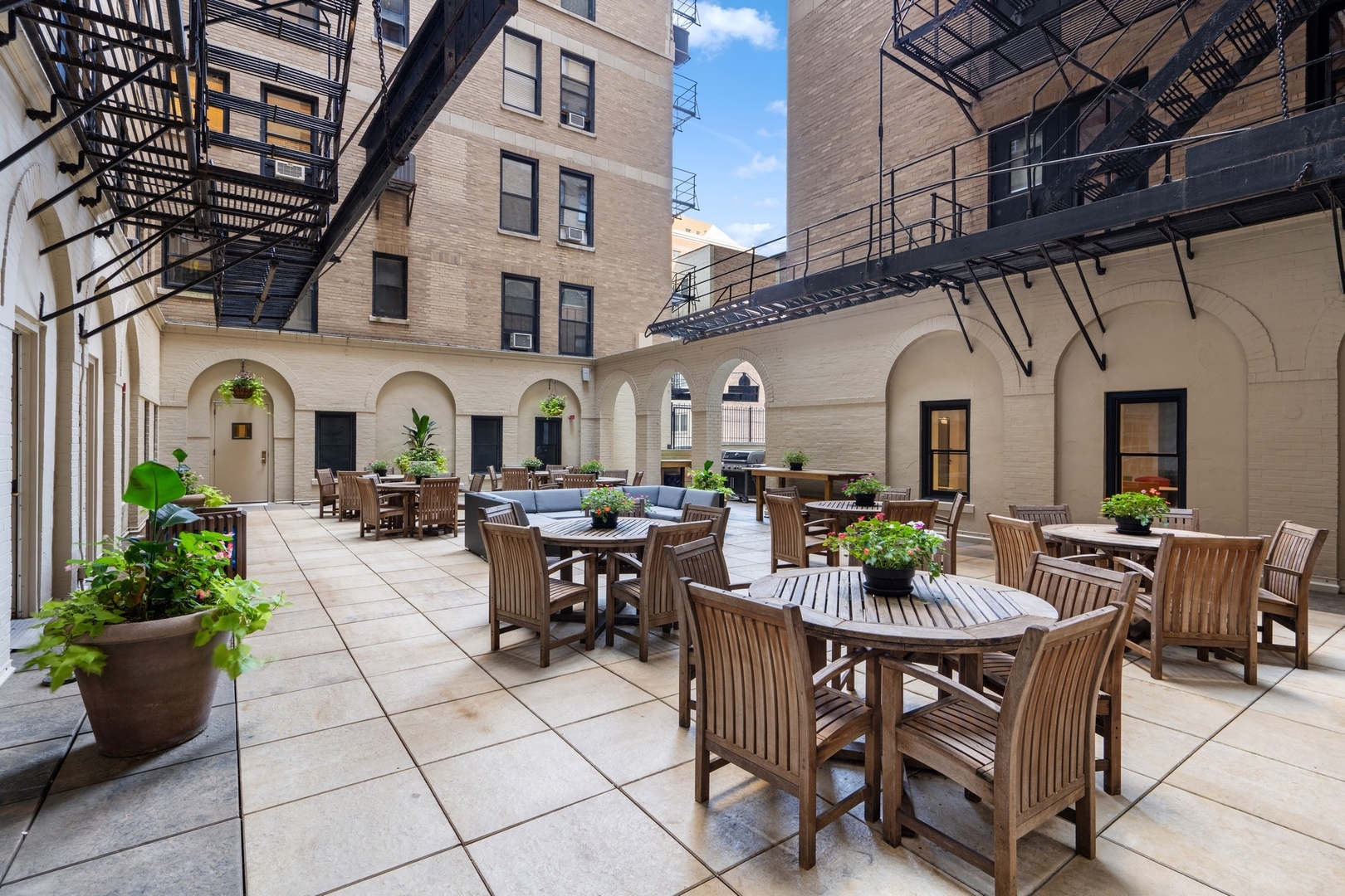3100 North Sheridan Road, Unit 14B Chicago, IL 60657 - Photo 50 of 50 a view of a patio with table and chairs potted plants and couches