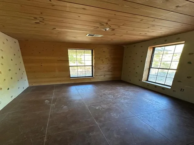 a bathroom with a toilet and a mirror