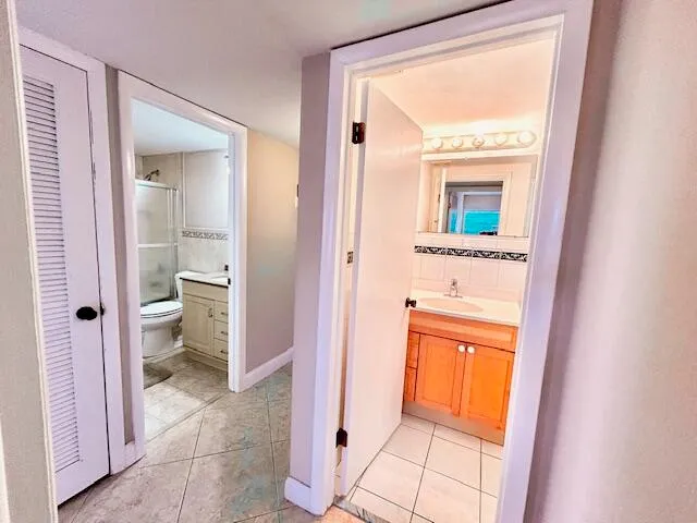 a view of a bathroom from a hallway