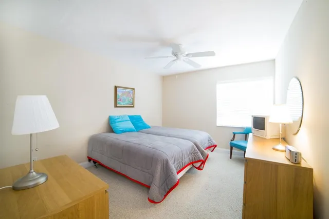 a bedroom with a bed and a lamp