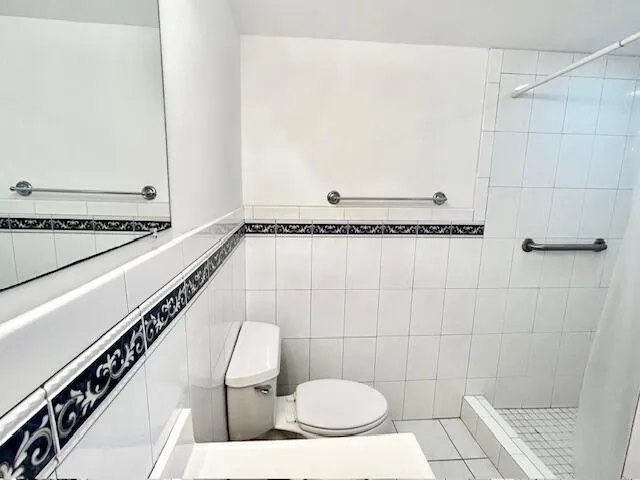 a bathroom with a toilet and a shower