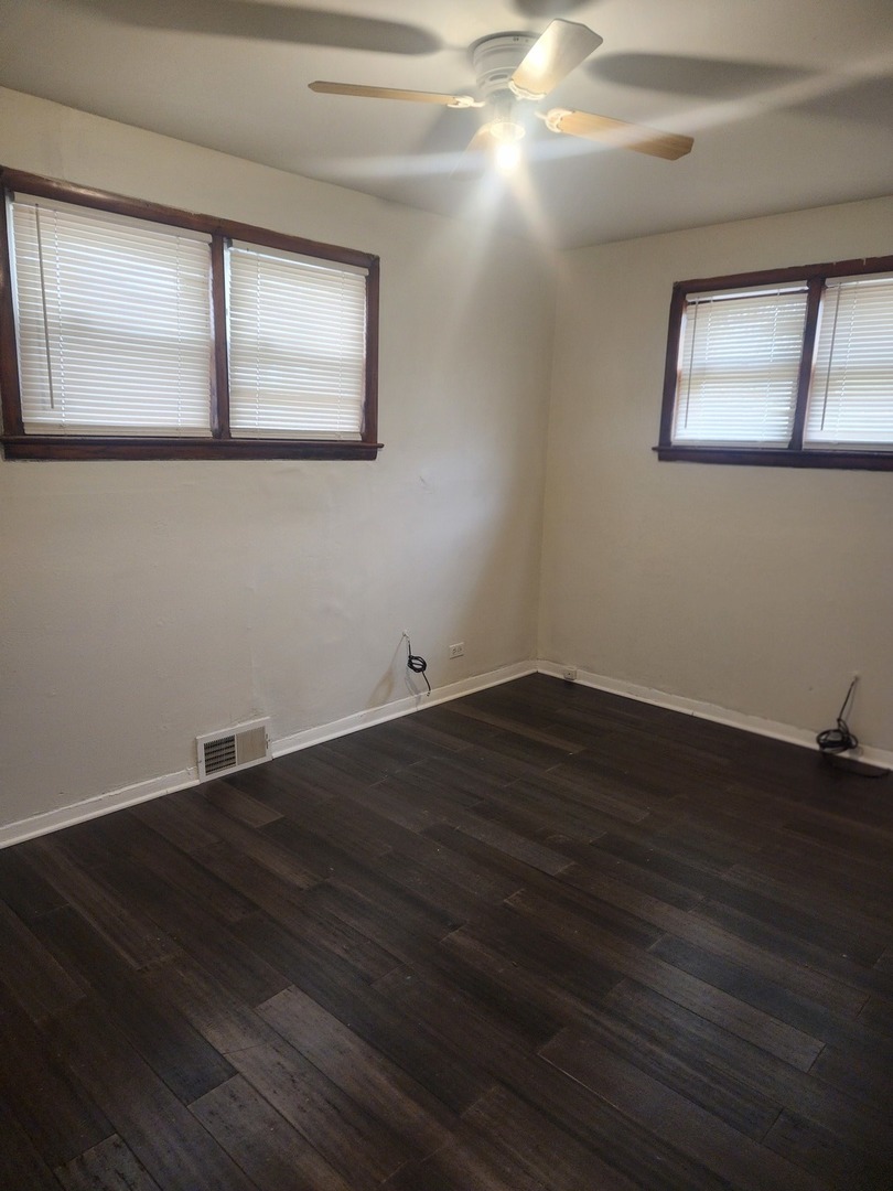 948 West Vermont Street Chicago, IL 60643 - Photo 5 of 9 a view of empty room with wooden floor and fan