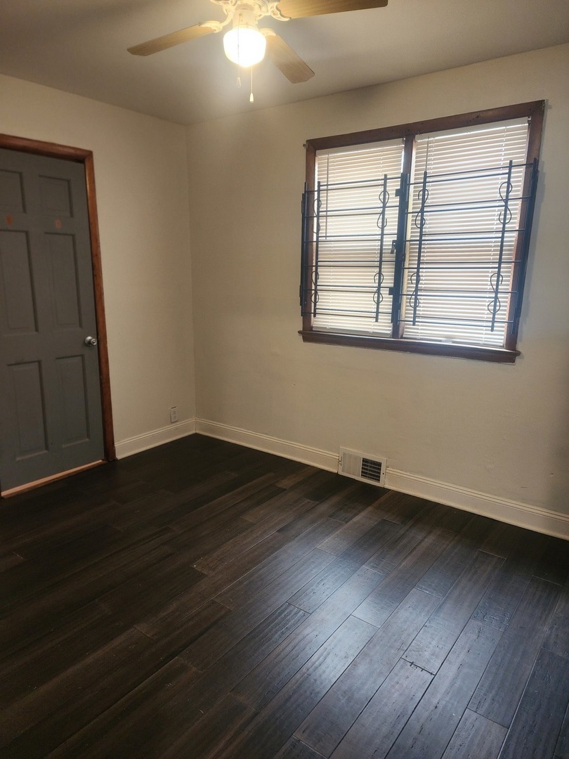 948 West Vermont Street Chicago, IL 60643 - Photo 6 of 9 a view of an empty room with wooden floor and a window