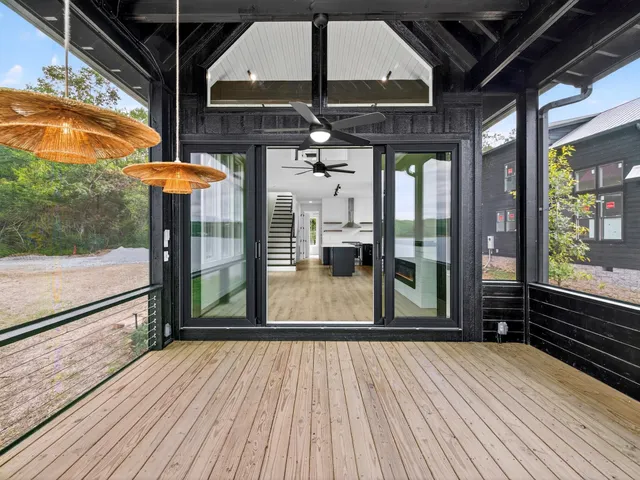 a view of a room with wooden floor a ceiling fan