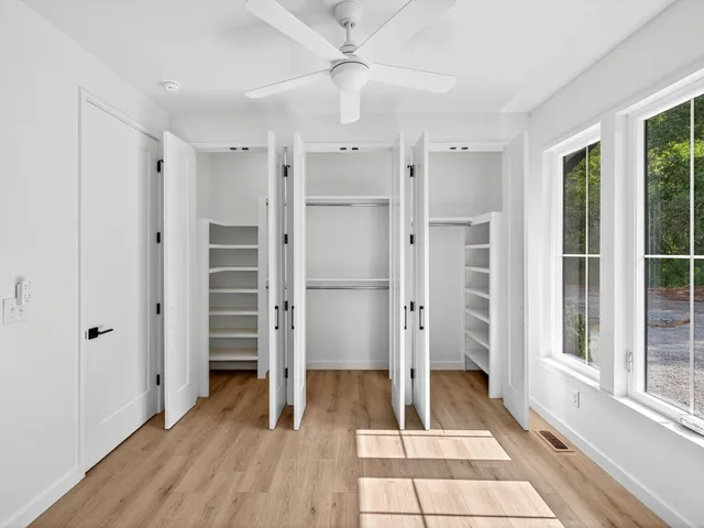 an empty room with wooden floor and a window