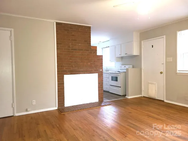 a view of a kitchen with a sink and a stove top oven