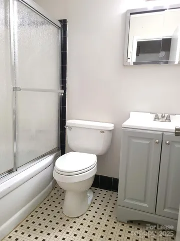 a bathroom with a toilet sink and shower