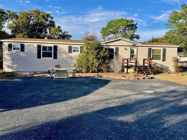 a front view of a house with sitting area