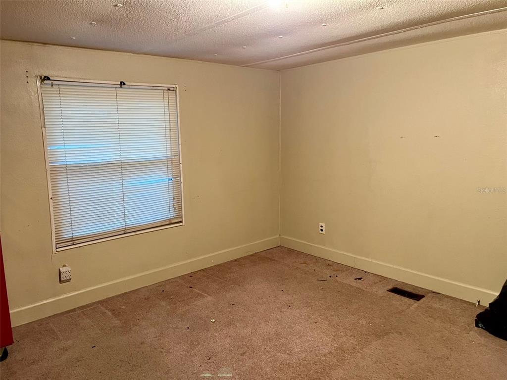 9525 Scot Street Hudson, FL 34669 - Photo 11 of 17 an empty room with a window