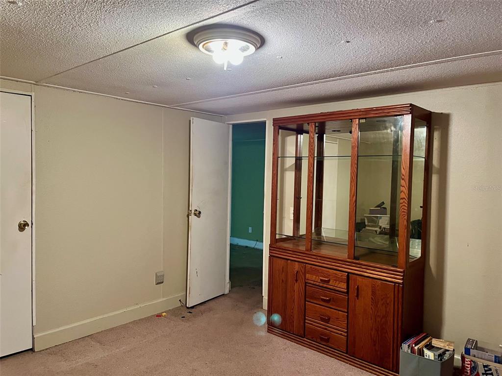 9525 Scot Street Hudson, FL 34669 - Photo 12 of 17 an empty room with window and cabinet