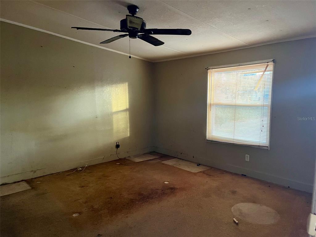 9525 Scot Street Hudson, FL 34669 - Photo 14 of 17 a view of an empty room with a window