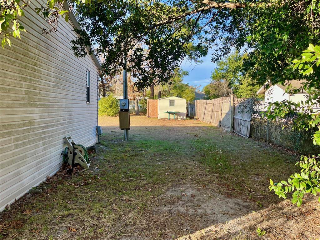 9525 Scot Street Hudson, FL 34669 - Photo 5 of 17 a backyard of a house with lots of green space