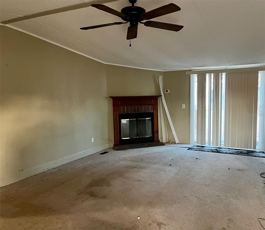 9525 Scot Street Hudson, FL 34669 - Photo 8 of 17 an empty room with windows and fireplace