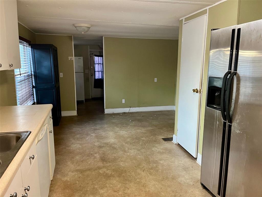 9525 Scot Street Hudson, FL 34669 - Photo 10 of 17 a view of a kitchen with a refrigerator a sink and dishwasher