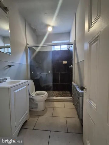 a bathroom with a toilet a sink and shower