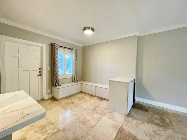 a spacious bedroom with a bed and a window