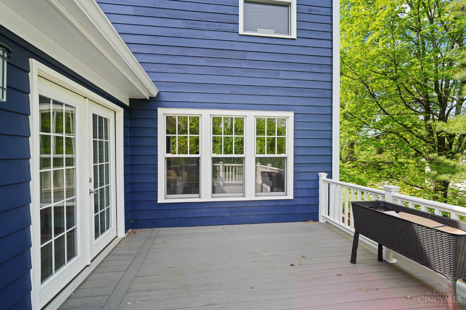 2780 Walsh Road Cincinnati, OH 45208 - Photo 59 of 77 The rear deck seamlessly extends from the screened porch, creating an ideal indoor-outdoor flow for relaxing and entertaining. Constructed with low-maintenance composite decking, it offers both durability and lasting appeal. Generously sized and thoughtfully positioned, the deck provides a pleasant vantage point overlooking the backyard—perfect for morning coffee, outdoor dining, or enjoying the surrounding greenery in comfort.