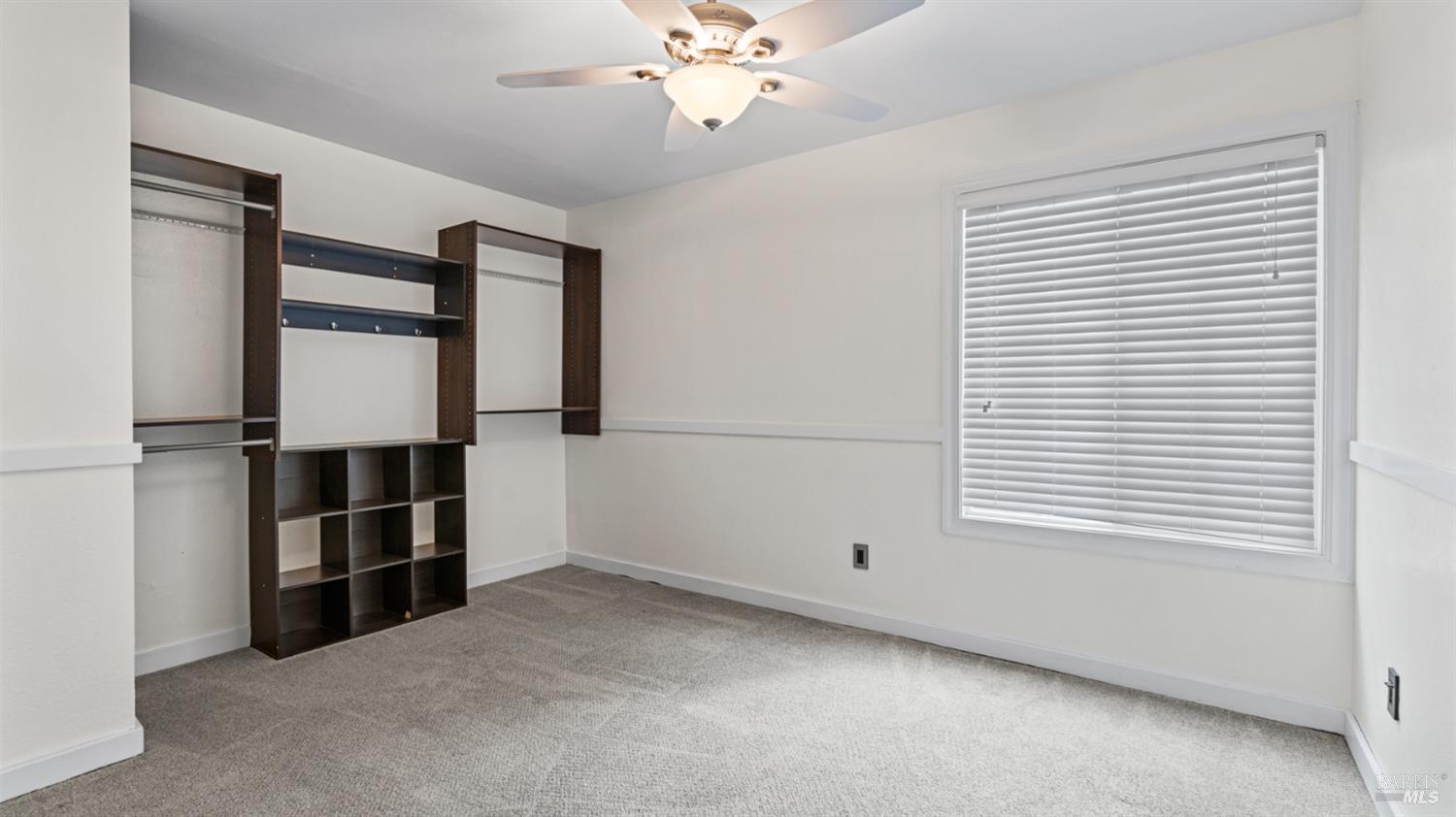 6454 Amberwood Street Rohnert Park, CA 94928 - Photo 11 of 18 Down the hall from the Primary Bedroom, affording good separation, is the second and third bedrooms, side by side. Creative closet arrangement. Overhead light and fan as well.