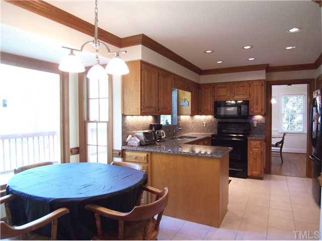 2016 Chichester Court Raleigh, NC 27615 - Photo 5 of 12 Spacious KIT has lots of maple cabs; NEW: granite ctrs & backsplash, tile flr, smooth-top range w/self clean oven, DW, MW, SS sink/faucet w/garden window above; pantry; recessed lights & lg bay-windowed B'fast area overlooking the pretty bkyd. Kitchen