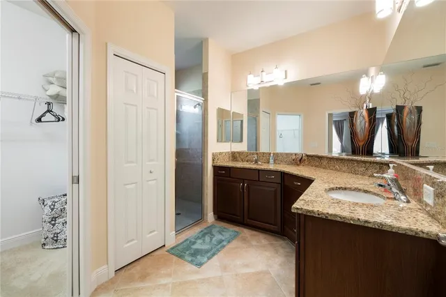 a bathroom with a granite countertop sink double and mirror