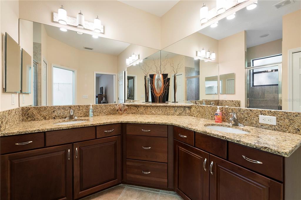 7608 Rio Bella Place Bradenton, FL 34201 - Photo 17 of 26 a bathroom with a granite countertop sink double and mirror