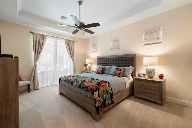 a bedroom with a bed and a flat tv screen on the dresser