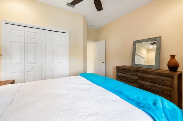 a bedroom with a bed and cabinets