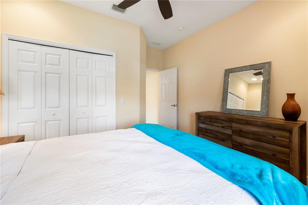 7608 Rio Bella Place Bradenton, FL 34201 - Photo 7 of 26 a bedroom with a bed and cabinets