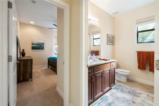 a bathroom with a toilet a sink and mirror