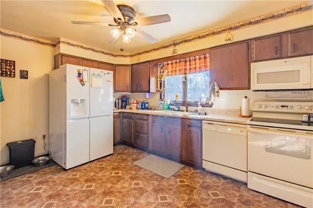 a kitchen with a refrigerator a sink and cabinets