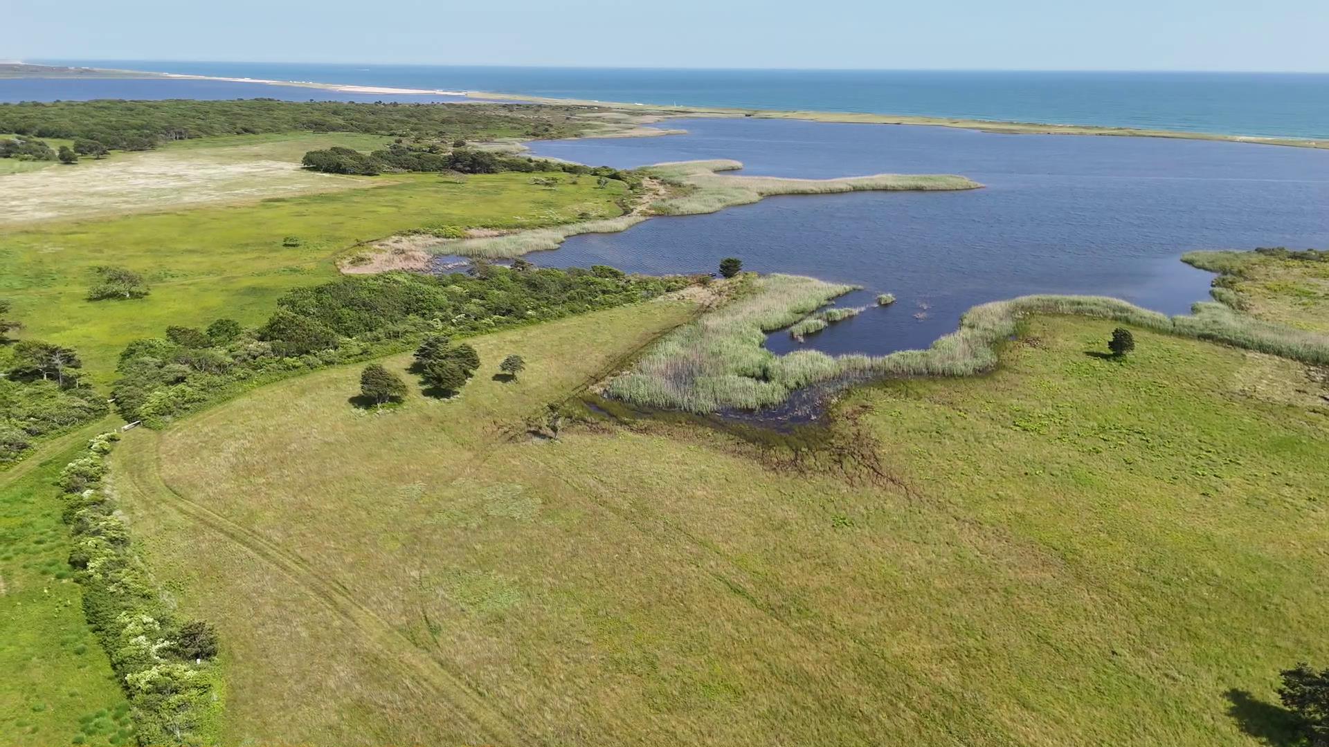 38 Black Point Road Chilmark, MA 02535 - Photo 35 of 38 a view of a lake with a mountain