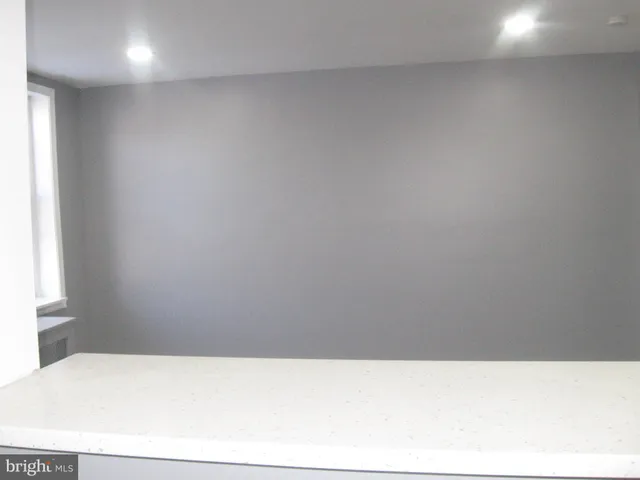 a room with a window and ceiling fan