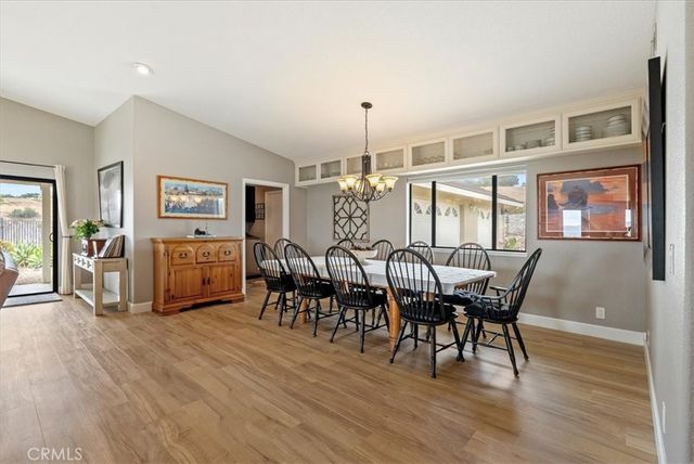 a kitchen with a refrigerator a sink dishwasher and wooden cabinets